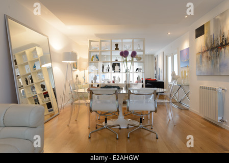 Dining room table and chairs in a modern and contemporary interior designed living room Stock Photo