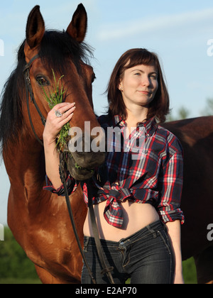 Groom girl with race horse walking Stock Photo