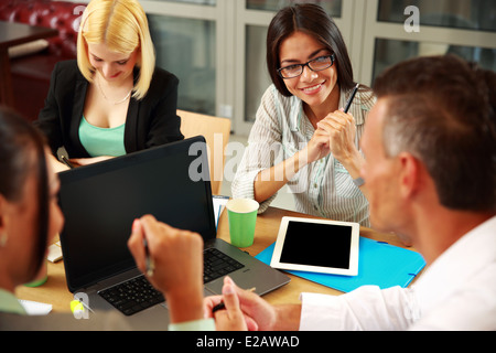 Business people having meeting around table in office Stock Photo