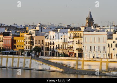 Spain, Andalucia, Seville, Triana, Calle Betis and Guadalquivir, church steeple Santa Ana at sunrise Stock Photo