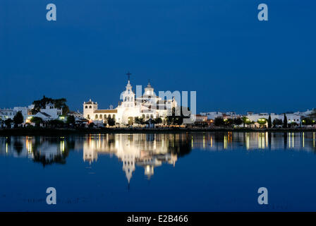 Spain, Andalucia, El Rocio, Donana National Park, listed as World Heritage by UNESCO, church and village at dusk and there Stock Photo