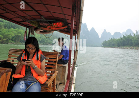 China, Guangxi province, Guilin region, Karst mountain landscape and Li River around Yangshuo, Chinese tourist on a raft Stock Photo