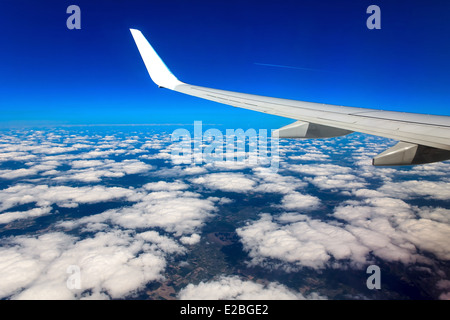 Clouds, sky and earth as seen through window of an aircraft Stock Photo