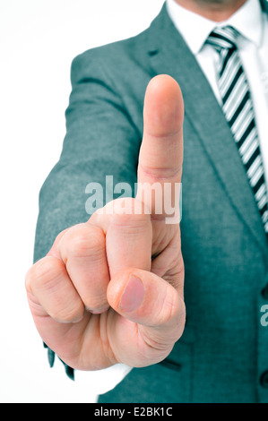 a businessman wearing a suit holding up his index finger Stock Photo