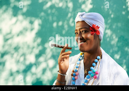 Portrait of african cuban woman smoking cohiba cigar and looking at camera smiling Stock Photo