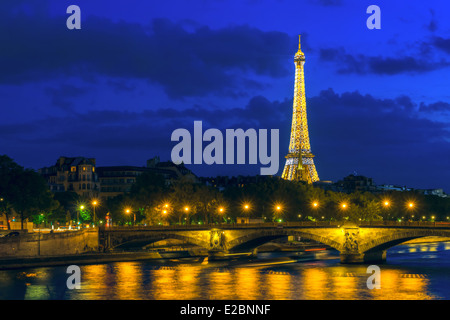 PARIS - MAY 9: Cityscape of Paris with Eiffel Tower (Tour Eiffel) and Pont des Invalides at night illumination on May 9, 2014. T Stock Photo