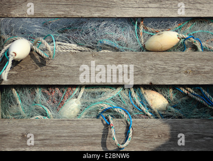 Blue industry fishing nets in old wooden storage box Stock Photo