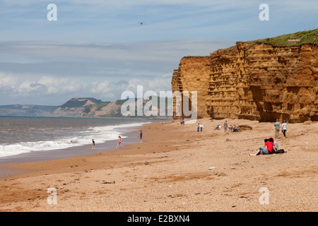 People on the beach in summer, Hive Beach, Burton Bradstock, the Jurassic Coast, Dorset England UK Stock Photo