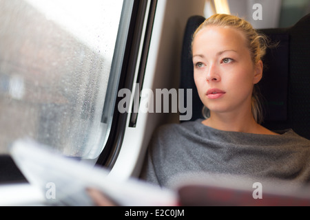 Lady traveling by train. Stock Photo
