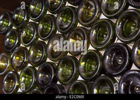 Bottoms of wine bottles on a shelf of wine cellar Stock Photo