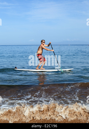 Man stand up paddle surfing at Wailea Beach on Maui Stock Photo