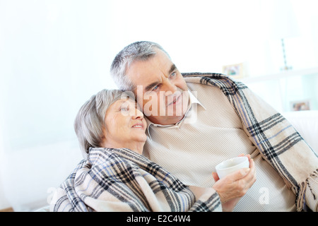 Image of couple of pensioners having tea at home Stock Photo