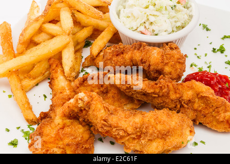 Fried chicken tenders served with french fries and coleslaw. Stock Photo