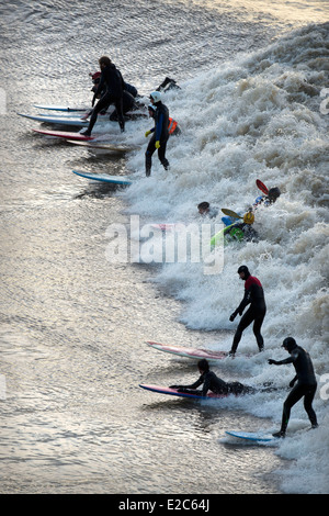 Surfers and canoeists riding the Severn Bore at Newnham-on-Severn, Gloucestershire UK 2014 Stock Photo