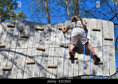 France, Herault, Beziers, wood of Bourbaki, park of adventure in forest consisted of Tyrolean and of climbing walls, teenager escladant a wooden wall Stock Photo