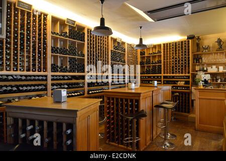 France, Herault, Beziers, square Jean Jaures, wine bar and tapas Le Chameau ivre, dining room consisted of storerooms with wines settled in high tables along walls Stock Photo