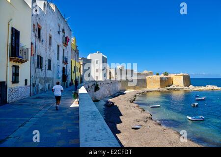 Italy, Sicily, Trapani, historic center, Promenade of Tramontana lined with houses with fortress Conca  in background Stock Photo