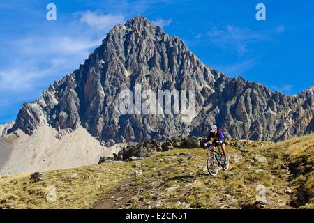 France Hautes Alpes mountain bike race the Ultra Raid Meije biker downhill to Alpe Lauzet Stock Photo