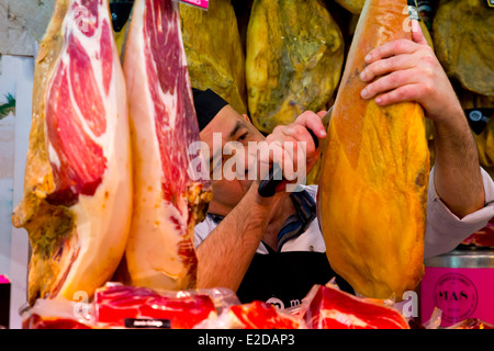 Man cutting traditional Ham on the Mercat de Sant Josep de la Boquería in Barcelona, Spain