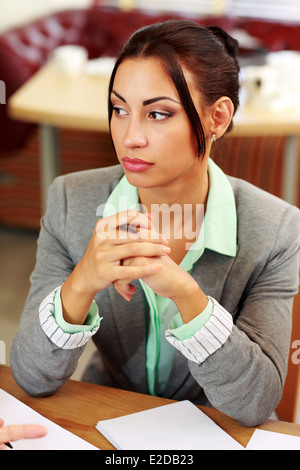 Portrait of a pensive businesswoman looking away in office Stock Photo