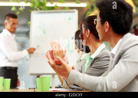 Business people applauding in a meeting. Business concept. Stock Photo
