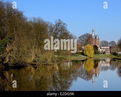 Springtime tree-lined canals with views on Sassenpoort or Sassen Gate,  medieval gatehouse in  Zwolle, The Netherlands Stock Photo