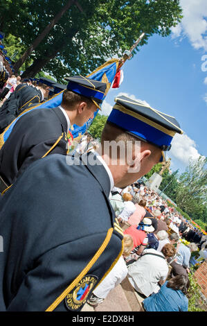 Warsaw, Poland 19th June 2014. The Catholic congregation of eastern side of Warsaw, the capital city of Poland, celebrated The Feast of Corpus Christi on Thursday, 60 days after Easter. The procession at the Saint Florian Cathedral attracted hundreds of people, in particular local firefighters as Saint Florian is considered a patron of firemen. Children throw petals before the priest carrying the  monstrance. Credit:  Henryk Kotowski/Alamy Live News Stock Photo