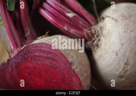 closeup view of two red beets, one cut in half Stock Photo