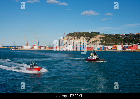 New Zealand, North Island, Napier. Waterfront port area. Shipping cargo and container pier with pilot and tug boat. Stock Photo