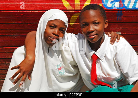 Tanzania, Mwanza region, Mwanza, muslim and christian students hugging as friends Stock Photo