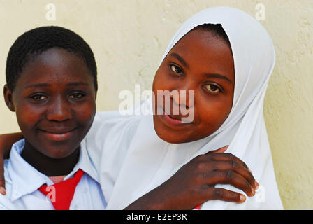 Tanzania, Mwanza region, Mwanza, muslim and christian students hugging as friends Stock Photo