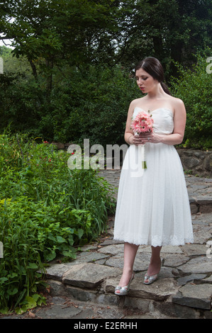 A bride walking down stone steps Stock Photo