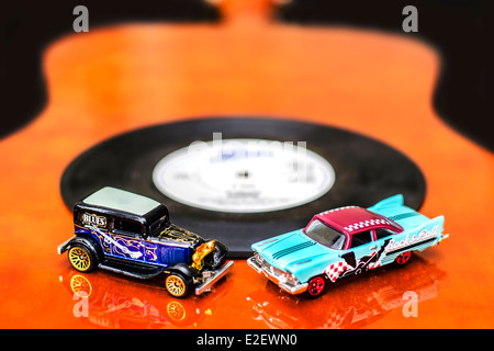 Blues and Rock Cars Miniature Toys on Guitar Stock Photo