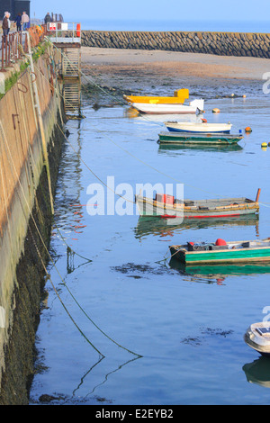 Victorian seaside town fishing boats moored at high tide Folkestone Kent Stock Photo