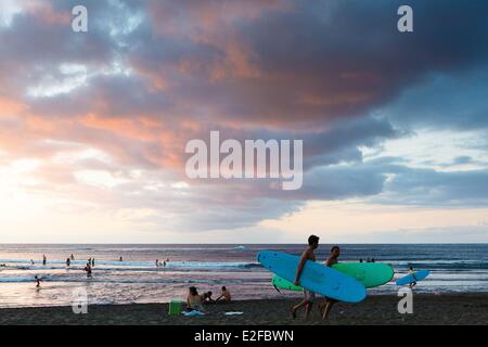 France, Reunion island (French overseas department), Etang Sale, Etang Sale les Bains, seascape swimmers and surfers at sunset Stock Photo