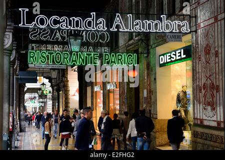 Italy, Liguria, Genoa, Via XX Settembre, arches and illuminated signs Stock Photo