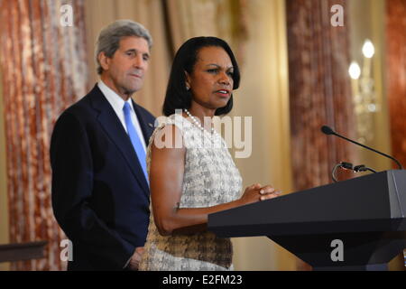 US Secretary of State John Kerry listens as former Secretary of State Condoleezza Rice speaks at the portrait unveiling ceremony and reception in honor of the former Secretary at the Department of State June 18, 2014 in Washington, DC. Stock Photo