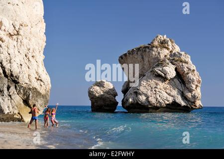 Cyprus Paphos District Petra tou Romiou Aphrodite's Rock young women photographied at the foot of the rock Stock Photo