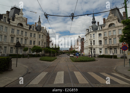 A photograph of a street scene with tram lines in Antwerp, Belgium. The Zurenborg neighborhood is a little off the beaten track. Stock Photo
