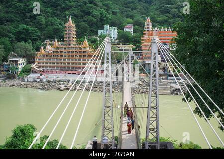 India Uttarakhand State Rishikesh the world capital of Yoga on the banks of the Ganga river Lakshman Jhula Bridge Stock Photo