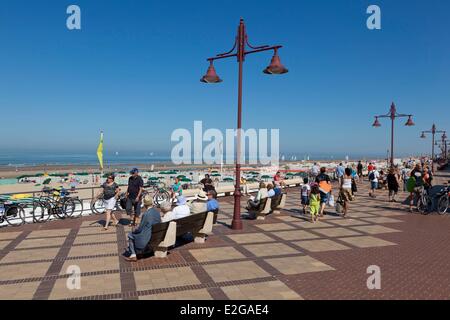 Belgium West Flanders De Haan walkers on the promenade of the seaside resort Stock Photo