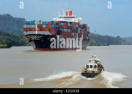 Panama Panama Canal at Gamboa Korean Panamax container cargo and pilote boat Stock Photo