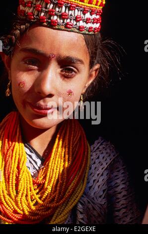 Pakistan Khyber Pakhtunkhwa Kalash valleys Bumburet valley portrait young Kalash girl with a tender gaze and pensive Stock Photo