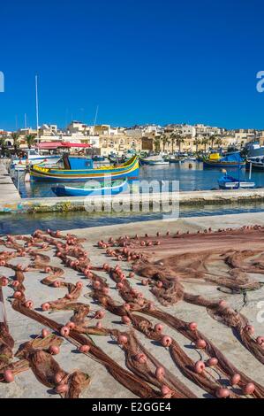 Malta Marsaxlokk is greater fishing harbor in Malta founded by Phoenicians during ninth century BC traditional boats or luzzi Stock Photo