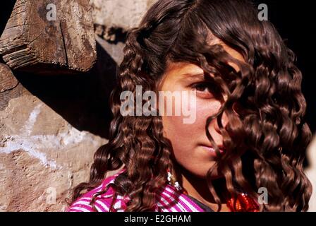 Pakistan Khyber Pakhtunkhwa Kalash valleys Bumburet valley young Kalash girl who has just undone her plaits Stock Photo