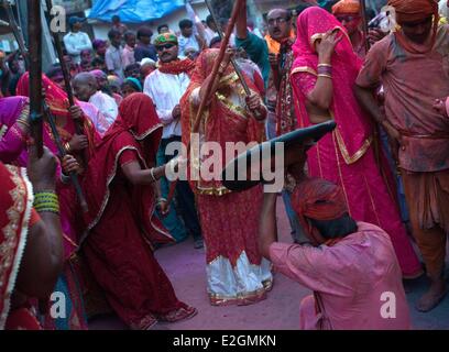 India Uttar Pradesh State Mathura during celebration of Lathmar Holi on this particular occasion women have freedom to beat men folk with long bamboo sticks called lathis Men are only allowed to protect themselves with shields Stock Photo