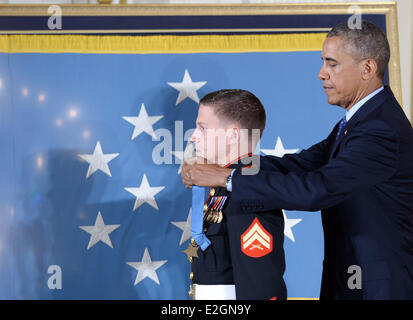 Washington, DC, USA. 19th June, 2014. William 'Kyle' Carpenter (L) receives the Medal of Honor from U.S. President Barack Obama during a ceremony in the East Room of the White House in Washington, DC, the United States, on June 19, 2014. Carpenter received the medal for covering a grenade to save fellow Marines during a Taliban attack in November 2010. Carpenter is the eighth living recipient chosen for the highest military award. Credit:  Yin Bogu/Xinhua/Alamy Live News Stock Photo