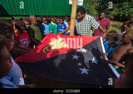 Papua New Guinea New Britain island West New Britain province Talasea district Cap Gloucester area Kilenge village kids and teachers are rising national flag on St Ignacius school Stock Photo