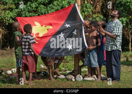 Papua New Guinea New Britain island West New Britain province Talasea district Cap Gloucester area Kilenge village kids and teachers are rising national flag on St Ignacius school Stock Photo