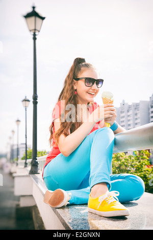 adorable teenager girl having fun and eating ice cream Stock Photo